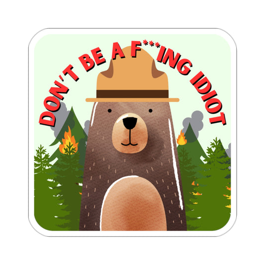 A square sticker featuring a brown bear with a ranger hat in front of a forest on fire that says "Don't Be a F***ing Idiot."